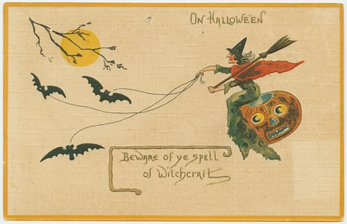 a witch riding on a jack o lantern, with bats towing her through the sky
