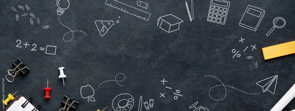 A black chalk board with an assortment of school utensils and different subjects icons draw on it